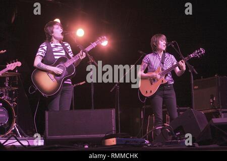 Canadian singer songwriters and identical twins Tegan Quin and Sara Quin, of the indie rock band Tegan and Sara, are shown performing on stage during a 'live' concert appearance. Stock Photo