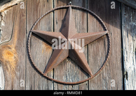 Rusty Lone Star sign on a wooden door in Texas. Stock Photo