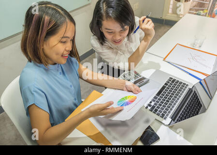Young office women discuss about sales report in office Stock Photo