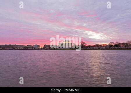 Washington DC panorama at sunrise during cherry blossom in spring. Cherry trees around Tidal Basin reservoir in urban landscape. Stock Photo
