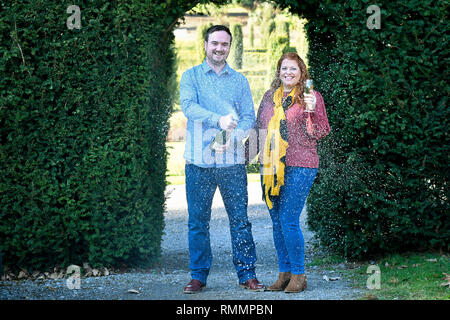 Andrew Symes and Natalie Metcalf, from Bristol, celebrate their £1 million win on the EuroMillions UK Millionaire Maker, at the De Vere Tortworth Court Hotel in Wotton-under-Edge, Gloucestershire. Stock Photo