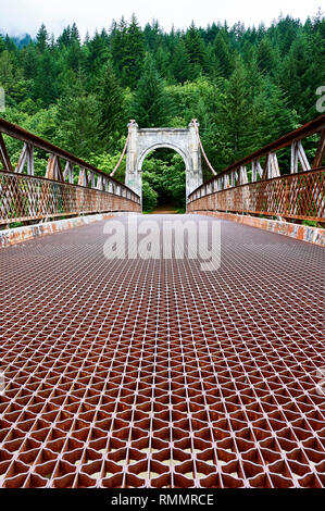 Low angle view of a rusty metal suspension bridge over the Fraser river near Lillooet along Highway 99, British Columbia, Canada Stock Photo