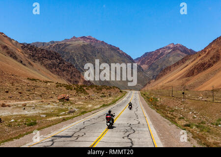 Two bikers on the National Route 7, here in the Andes, crosses Argentina from east to west connecting Buenos Aires to Santiago de Chile Stock Photo