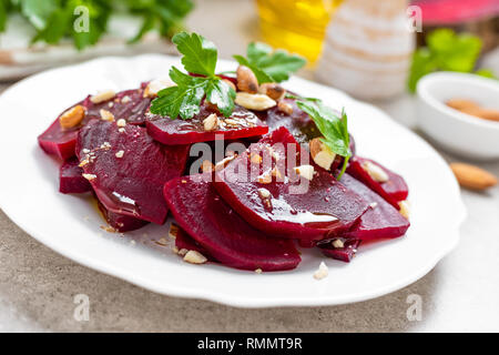 Vegetarian salad with boiled beet, almond nuts and oil. Healthy food Stock Photo