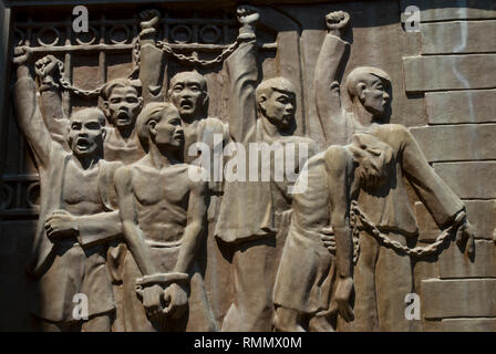 Bas relief of defiant Vietnamese prisoners being tortured by French, Hoa Lo prison, aka Hanoi Hilton, Hanoi, Vietnam Stock Photo