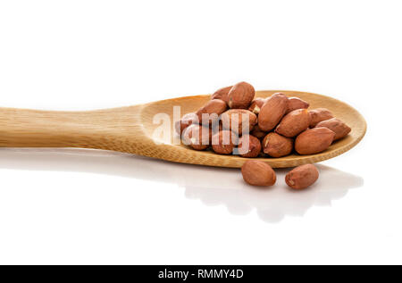 Peeled peanuts. A nut in a spoon. Large size premium quality. Isolated on white background. Stock Photo