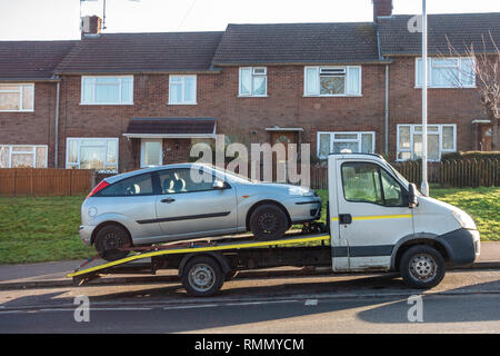 A car on the back of a tow truck. Stock Photo