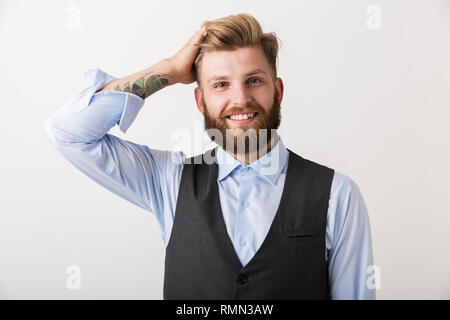 Portrait of a confident young bearded businessman standing isolated over white background Stock Photo