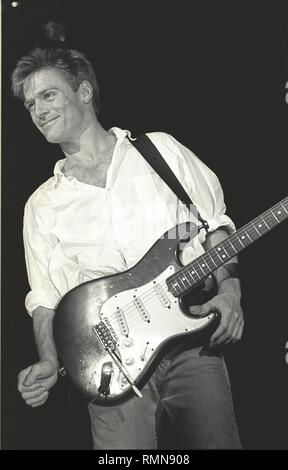 Singer, songwriter & guitarist Bryan Adams is shown performing on stage during a concert appearance. Stock Photo