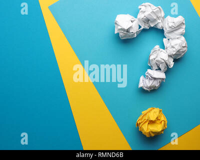 Question mark made with crumpled paper balls on a colorful background with space for text Stock Photo