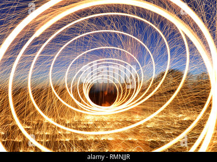 Steel wool photography. Light trails created by sparks during a long exposure photograph of burning steel wool. Stock Photo