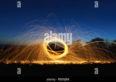 Steel wool photography. Light trails created by sparks during a long exposure photograph of burning steel wool. Stock Photo