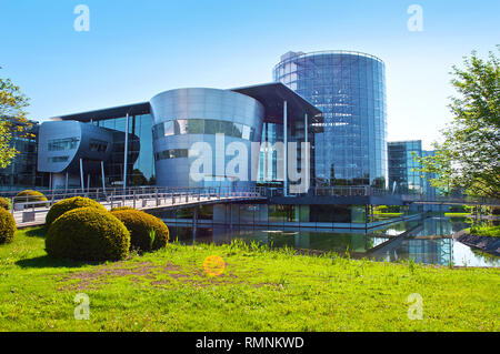 Dresden, Germany - April 18, 2018: View on the main entrance of Transparent Factory (Gläserne Manufaktur) in Altstadt on a cloudless spring day. - Ima Stock Photo