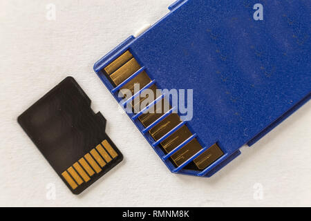 Close-up of micro SD memory card and SD adapter isolated on white copy space background. Modern technology concept. Stock Photo