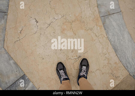 Top view of sport sneakers standing on the stone floor against the background Stock Photo
