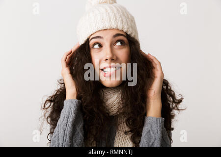 Happy young woman wearing winter clothes standing isolated over white background Stock Photo