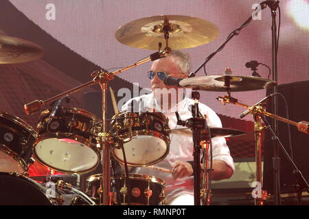 Drummer and singer Roger Taylor of the rock band Queen is shown performing on stage during a 'live' concert appearance. Stock Photo