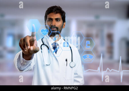 Indian doctor touching with index finger blue hexagon button on transparent screen as futuristic concept Stock Photo