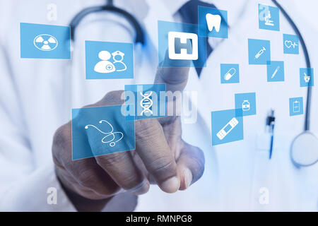 Close-up of index finger of indian doctor touching hospital sign on invisible display with medical and dentistry drawings Stock Photo