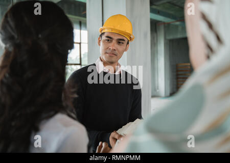 engineers in workwear are discussing their project. architect inspection on building site Stock Photo