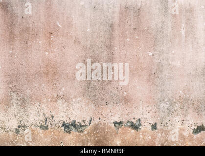 Dirty painted wall from the weathered, peeling and faded color,located in the urban area. Stock Photo