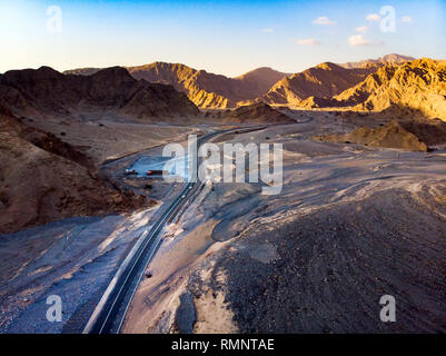 Desert road surrounded by sandstone rocks aerial view Stock Photo