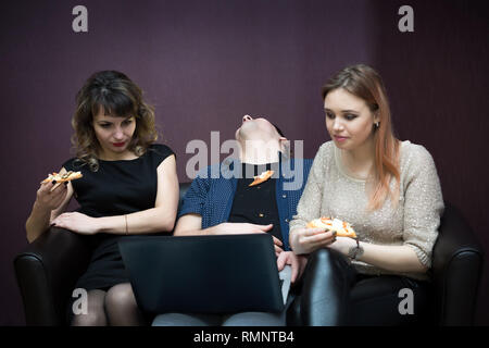 The girls watch a television series and the man fell asleep from boredom. Stock Photo