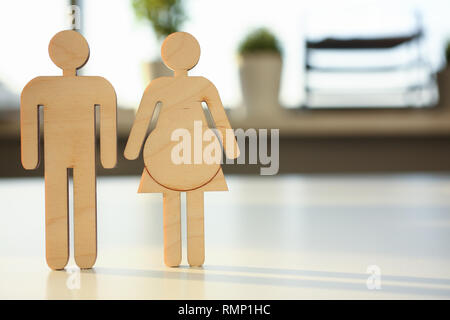 Wooden figures of people. Pregnancy. Stock Photo