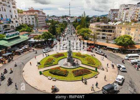 Dalat, Vietnam - September 23, 2018: People walk and ride a motorbike at the central Market Square on September 23, 2018, in Dalat, Vietnam Stock Photo