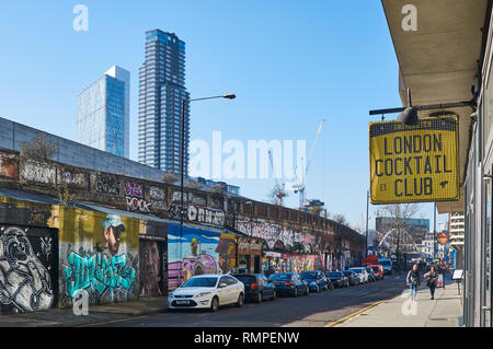 Sclater Street in Shoreditch, East London UK, with graffiti and high rise office buildings in background Stock Photo