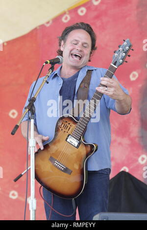 Musician Martin Sexton is shown performing on stage during a 