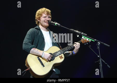 Singer, songwriter and guitarist Ed Sheeran is shown performing on stage during a 'live' concert appearance. Stock Photo