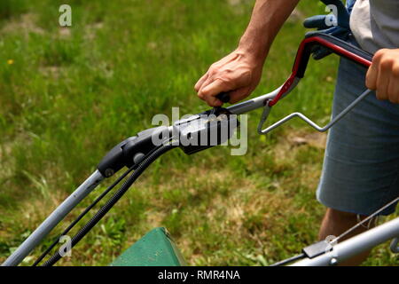 Starting an lawn mower to mow lawns. Stock Photo