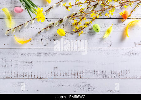 Easter flat lay background with spring flower, willow and easter eggs. Stock Photo