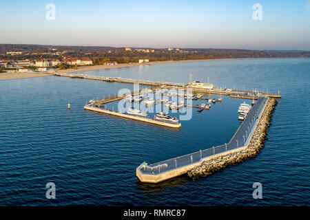 Poland, Sopot resort. Wooden pier (molo) with marina, yachts, sailboats, beach, vacation infrastructure, hotels, park and promenade. Aerial view at su Stock Photo