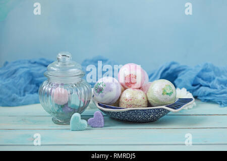 Handmade fragrant multicolored bath balls (bombs) and sugar scrub for hands. Selection focus on some balls. Stock Photo