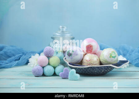 Handmade fragrant multicolored bath balls (bombs) and sugar scrub for hands. Selection focus on some balls. Stock Photo