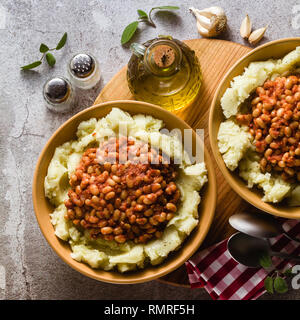 mashed potatoes with stewed white beans in tomatoes. winter warming recipe from vegan cuisine