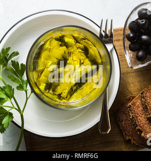 sardines marinated in olive oil with rye bread, salt and pepper on the table. Italian Neapolitan homemade Mediterranean cuisine recipe. light summer s Stock Photo