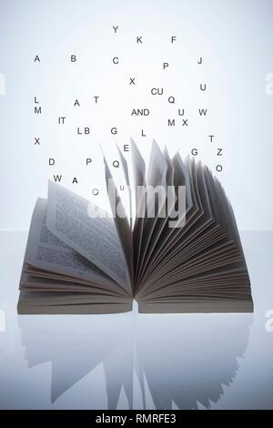 Open book with letters, conceptual image Stock Photo