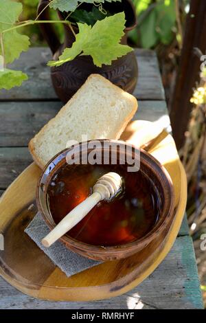 Still life with honey, grapes and white bread Stock Photo