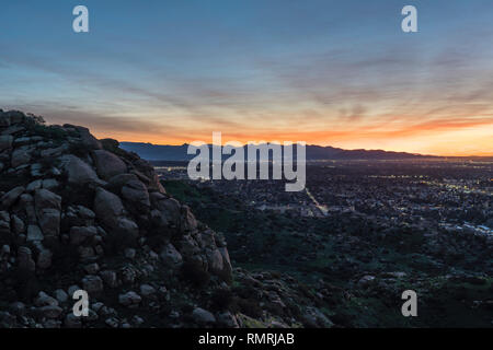 Dramatic dawn view of the San Fernando Valley neighborhoods from rocky hilltop in the city of Los Angeles, California. Stock Photo
