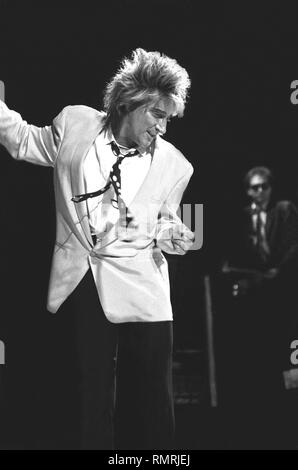 Singer and songwriter Rod Stewart is shown performing on stage during a 'live' concert appearance. Stock Photo