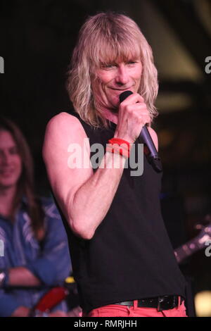 Singer Steve Whiteman is shown performing on stage during a 'live' concert appearance with Kix. Stock Photo