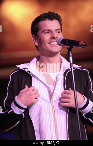 Singer, songwriter and actor Jordan Knight, best known as a singer in the boy band, New Kids on the Block (NKOTB), is shown performing on stage during a concert appearance with his solo band. Stock Photo