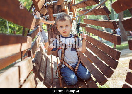 Little boy on an obstacle in an extreme park. Stock Photo