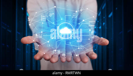 Man holding hologram projection displaying cloud technology symbols  Stock Photo