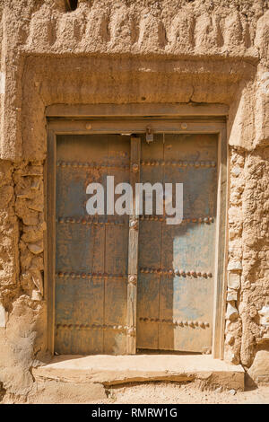 Ancient door of a mud house in the old village of Al Hamra (Oman) Stock Photo
