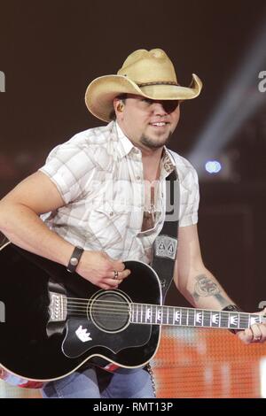 Country music star Jason Aldean is shown performing on stage during a live concert appearance. Stock Photo
