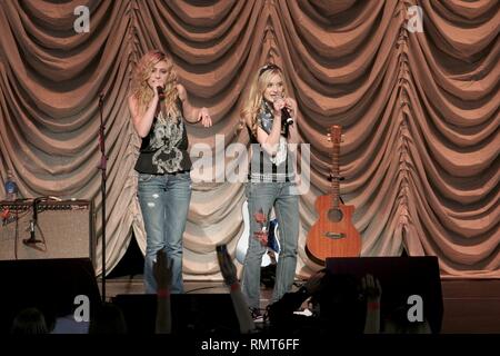 Aly & AJ are a teen pop duo consisting of sisters Alyson Renae 'Aly' Michalka and Amanda Joy 'AJ' Michalka. The sisters are shown performing together during a concert appearance. Stock Photo